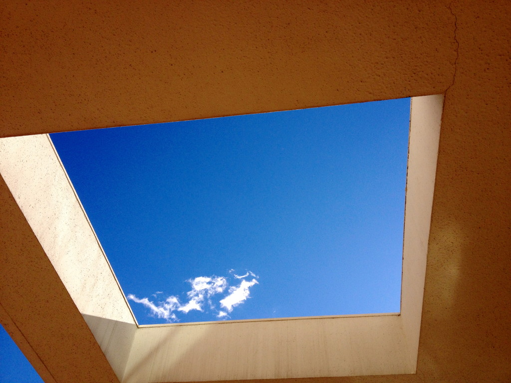 Blue sky through building