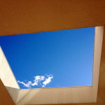 Blue sky through building
